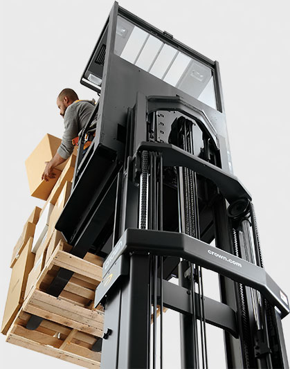 Forklift operator packs a pallet on an elevated rental forklift from Crown