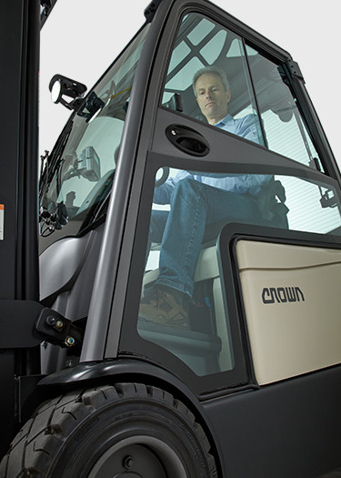 operator on Crown's SC 6000 series lift truck with hard cabin