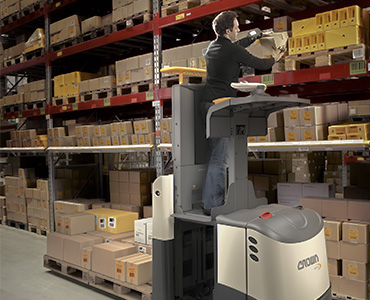 Operator using lift platform on GPC order picker forklift to reach higher