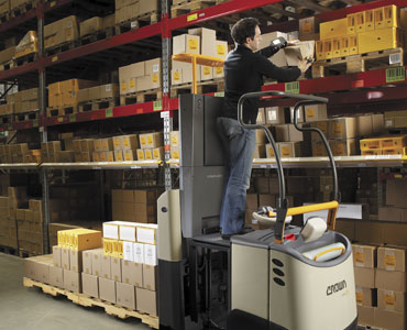 Operator using lift platform on GPC order picker forklift to reach higher