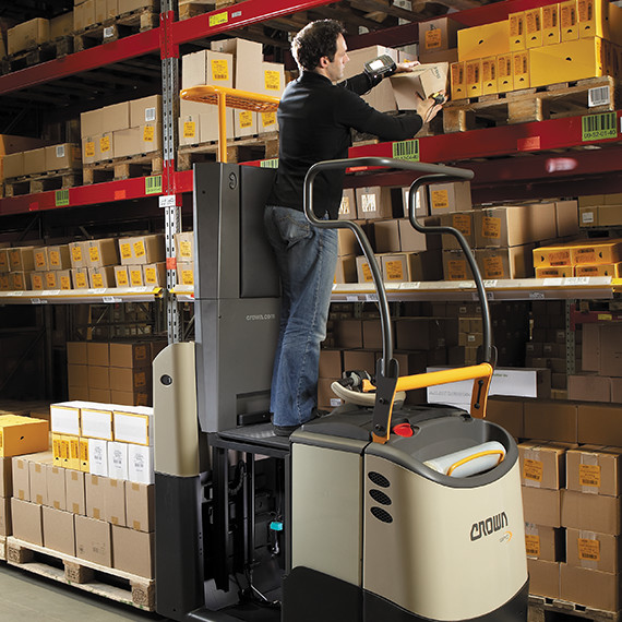 Operator using lift platform on GPC order picker forklift to reach higher