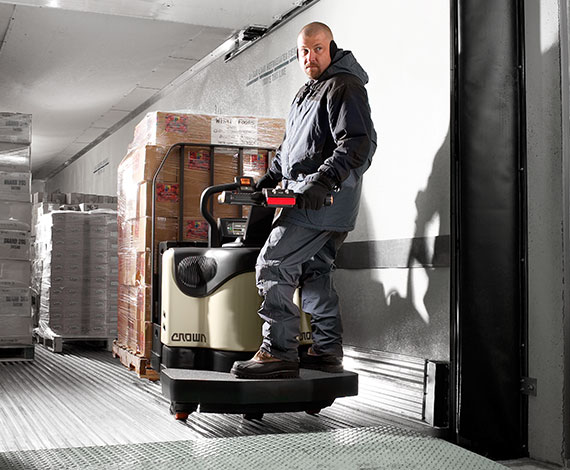 Operator unloads a truck using a Crown PE series end rider pallet truck