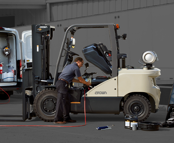 Service tech performing maintenance on C-G Series with body panels removed