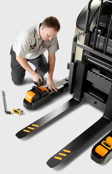 Service technician fixes wheel on Crown lift truck