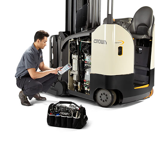 service technician performs maintenance on a crown reach truck