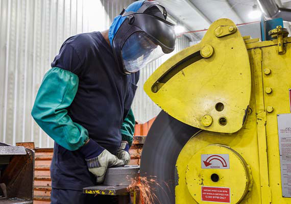 ID Castings worker cleaning iron pouring mold